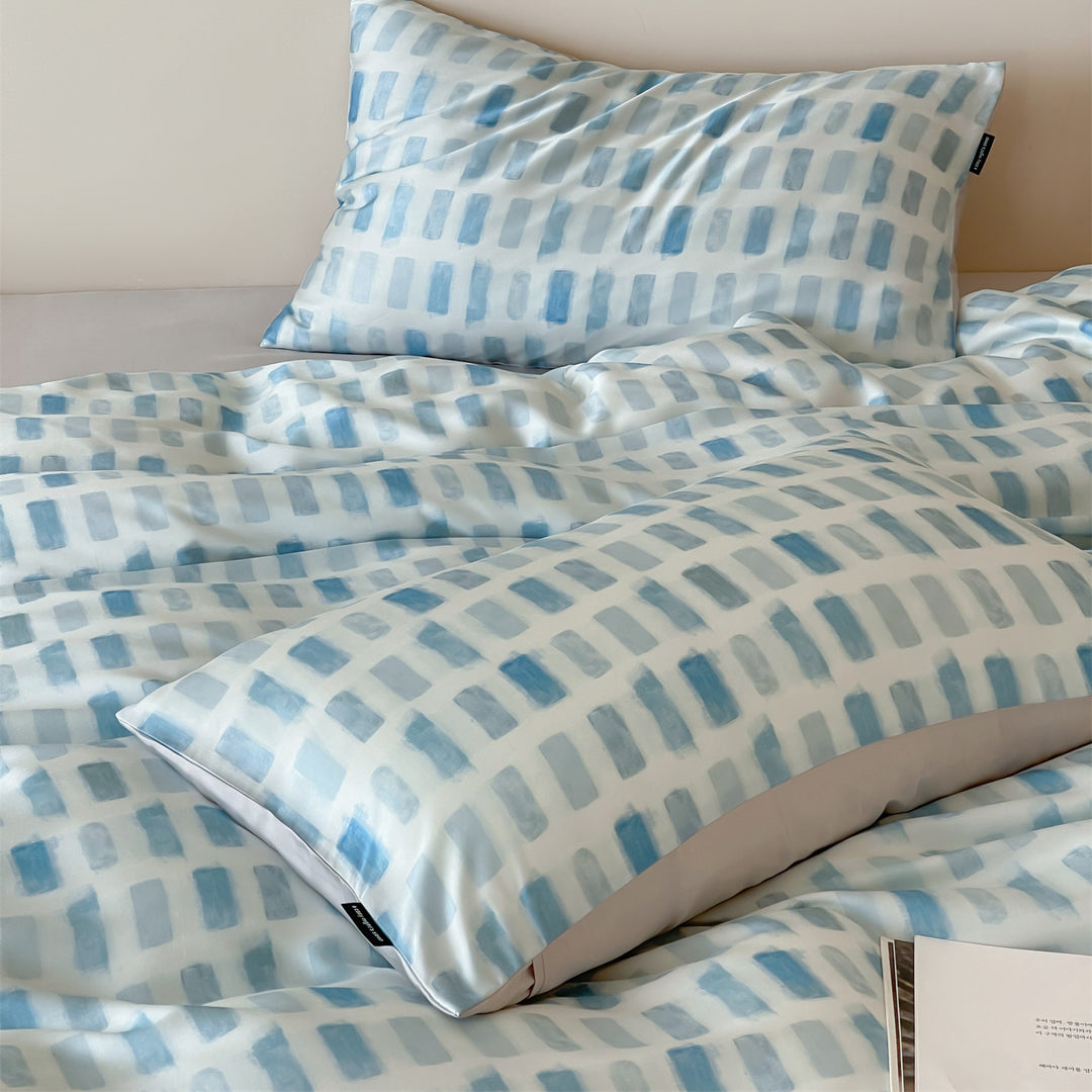 Luxurious satin bedding set with floral watercolor print, ruffled edges and reversible function
