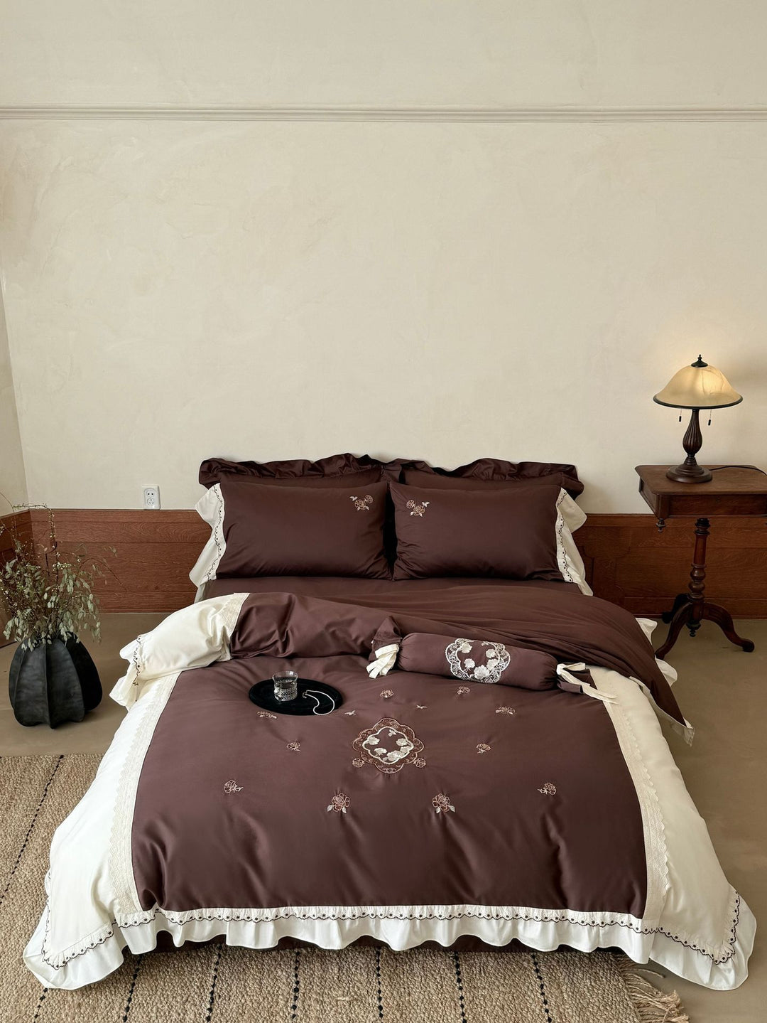 Luxurious embroidered bedding set with ruffle and decorative roll Stornfield