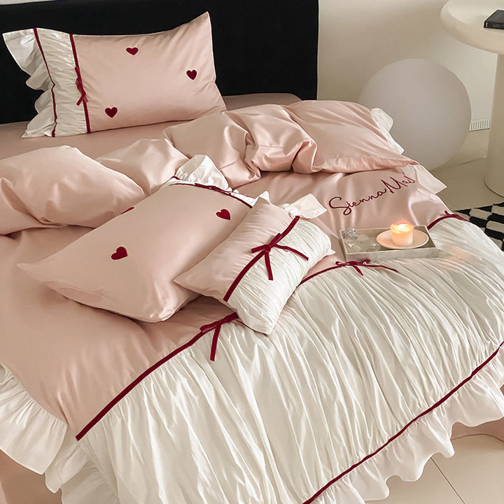 Romantic bedding set with ruffles, heart embroidery and luxurious satin look
