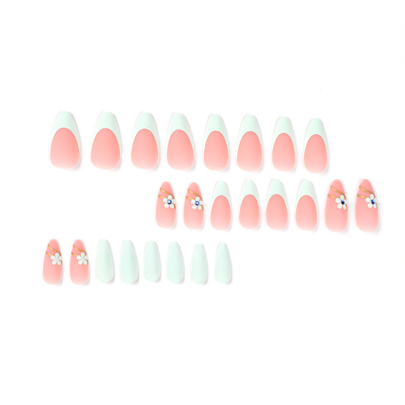Artistic stiletto nails with floral accents and glitter embellishments Stornfield