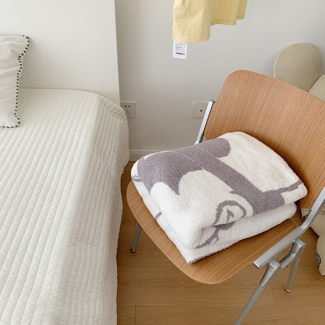 Cozy bedspread made of microfiber with a large woven cartoon motif