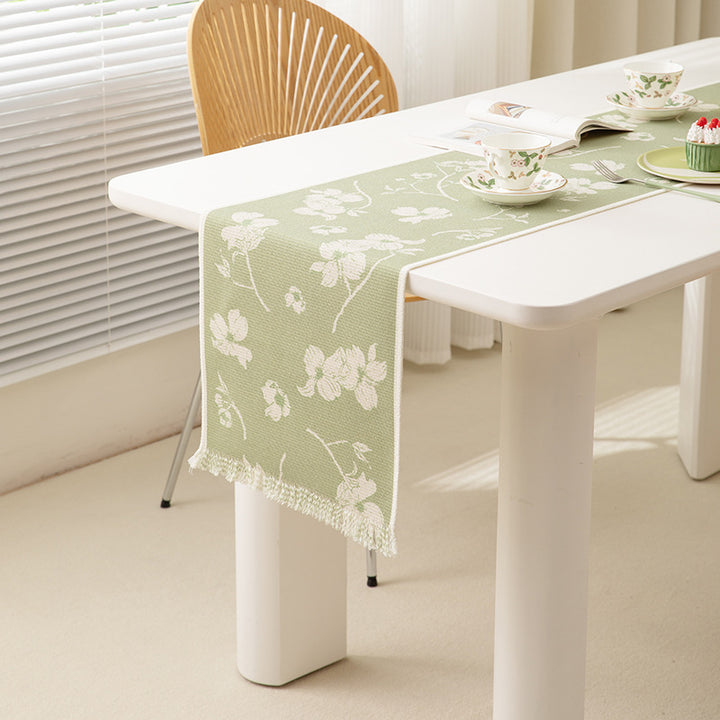 Woven table runner with floral jacquard pattern and fringed edge Stornfield