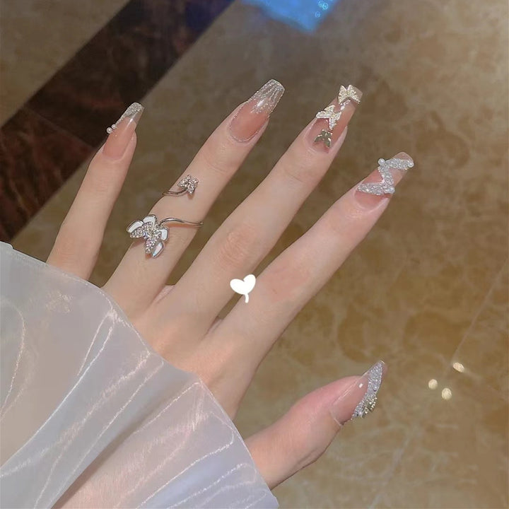 Trendy 3D design artificial nails with glitter and butterfly accents Stornfield