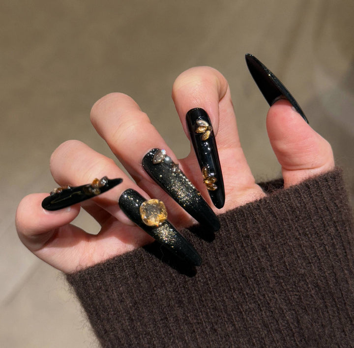Artistic Stiletto Press-On Nail Art with Glimmering Accents Stornfield