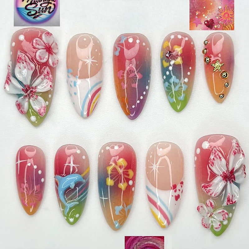 Artificial nail set with various designs and shiny embellishments Stornfield