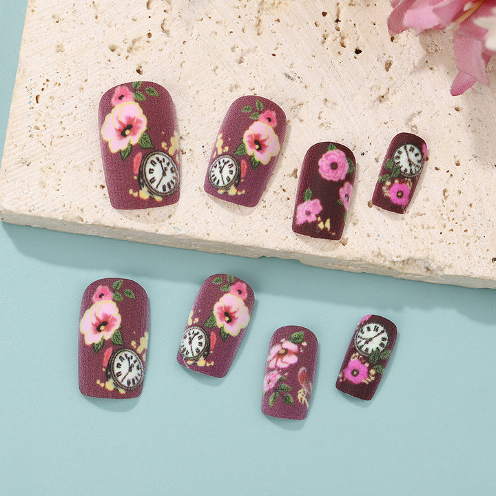 Nail art with floral design and intricate clock motifs Stornfield