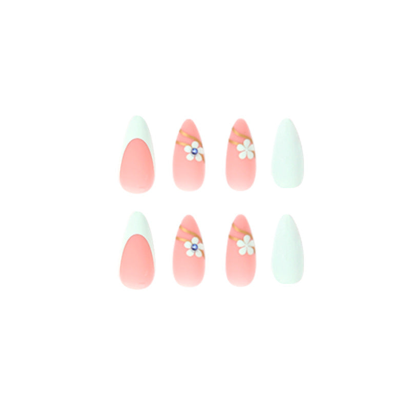 Artistic stiletto nails with floral accents and glitter embellishments Stornfield