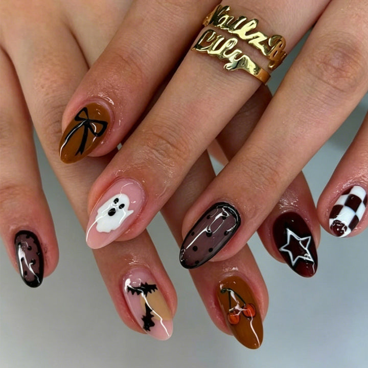 Artificial nail set with creative Halloween designs and glittering accents Stornfield