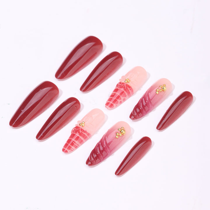 Artificial nail set with modern stiletto design and impressive flower appliqué Stornfield