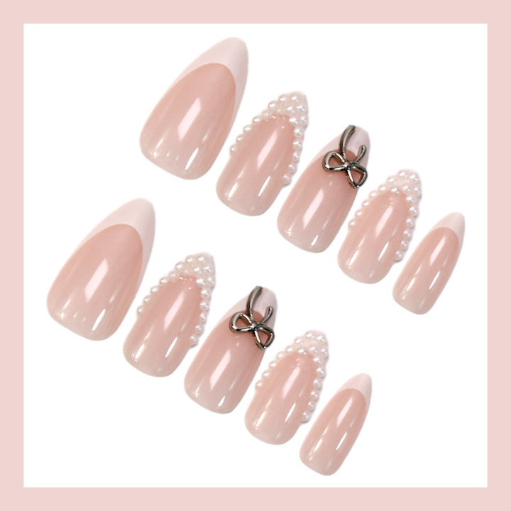 Glamorous artificial nail set with elegant bows and glitter accents Stornfield