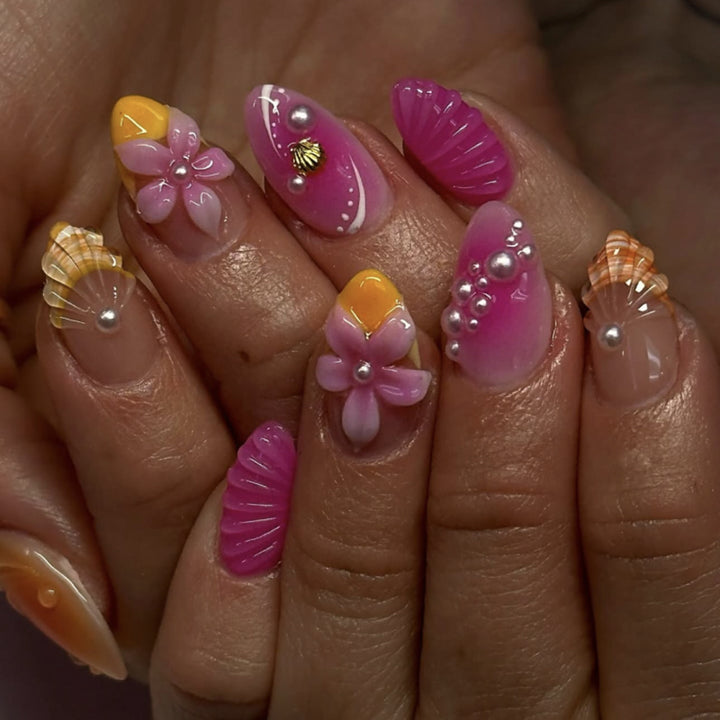 Artful nail extensions with floral and pearl-embellished accents Stornfield