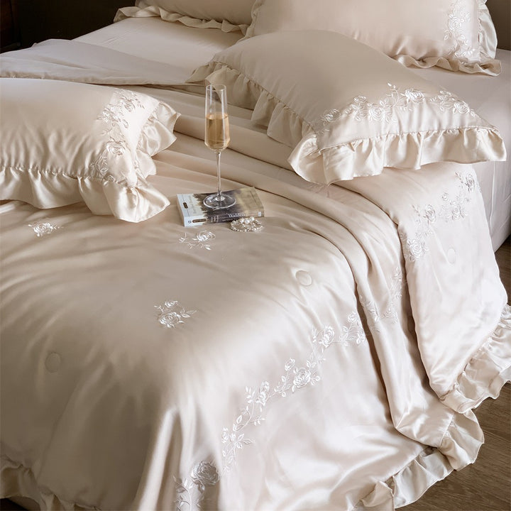 Satin bedding set with ruffled hem and fine rose embroidery