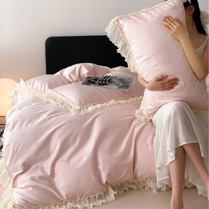 Elegant reversible bedding with romantic ruffle trim and subtle polka dot relief