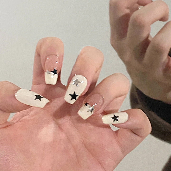 Artificial nail set with glamorous star design and sparkling accents Stornfield