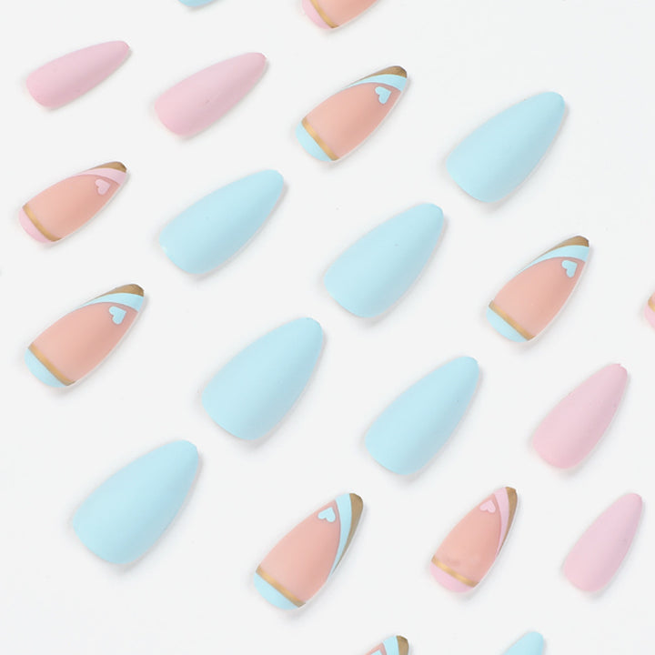 Artistic stiletto nails with gold accents and heart design Stornfield