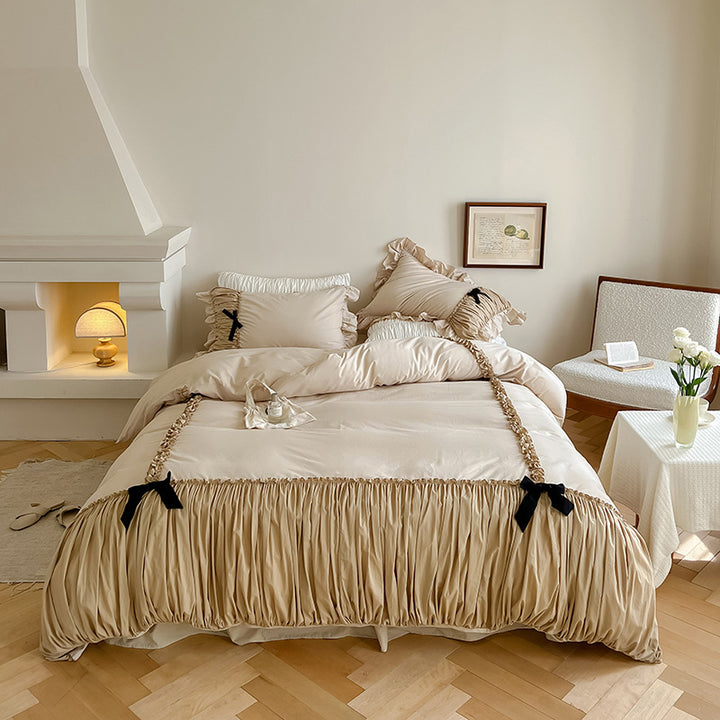 Luxurious satin bedding set with gathered ruffle, braided decorative ribbons and bow appliqué