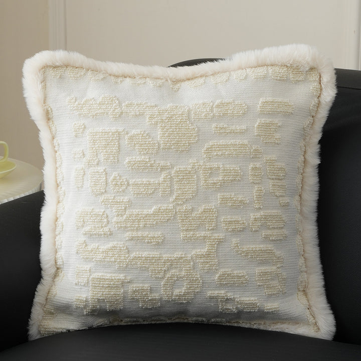 Square decorative pillow with embossed circular relief and soft faux fur edging