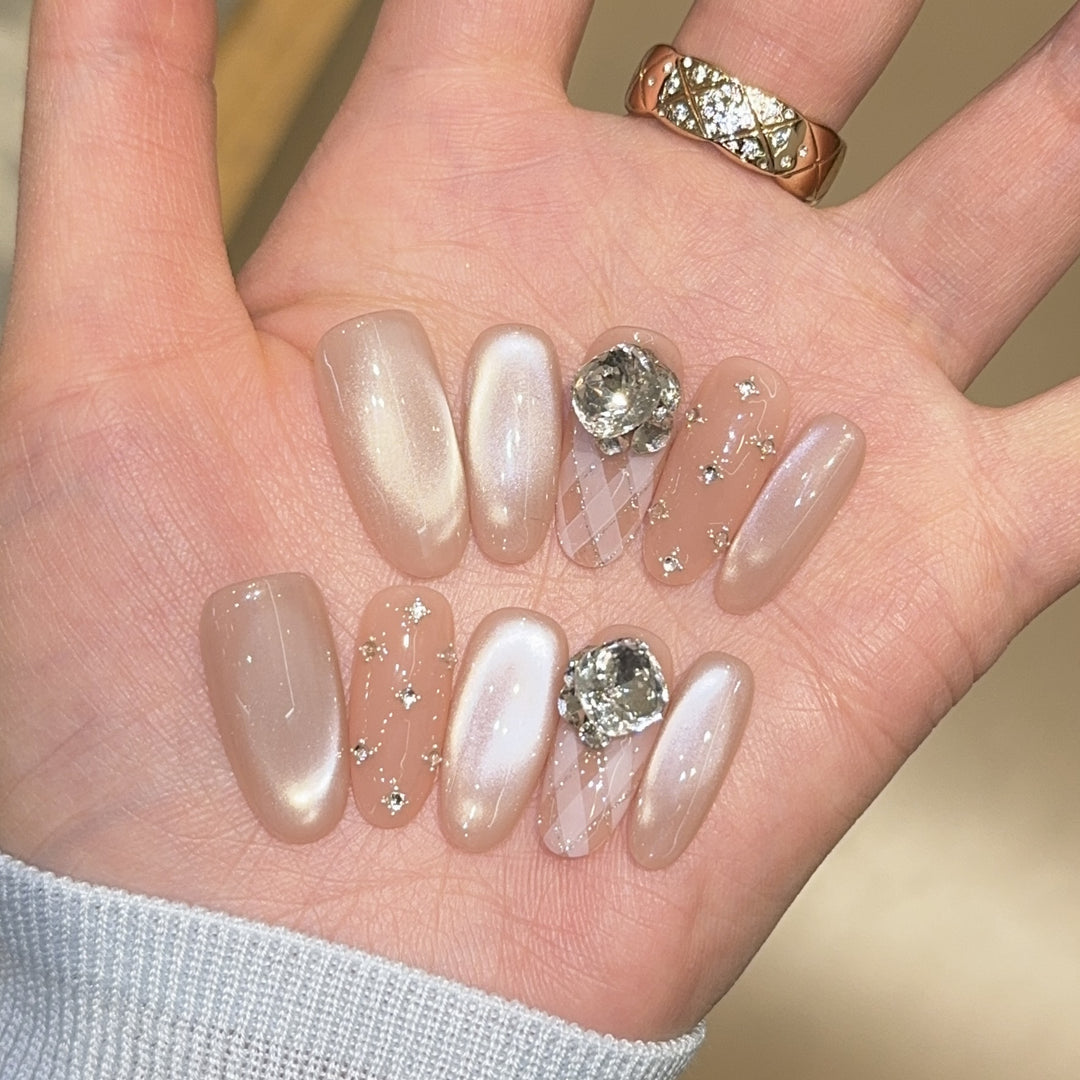 Elegant artificial nails with shimmering effects and rhinestone accents Stornfield