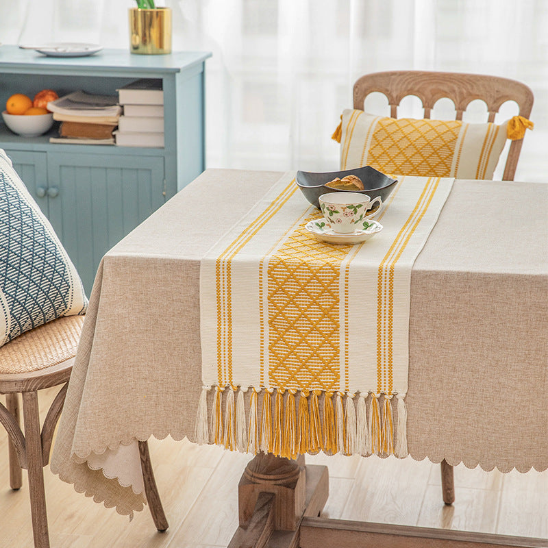 Handwoven cotton table runner with geometric center stripe and fringes
