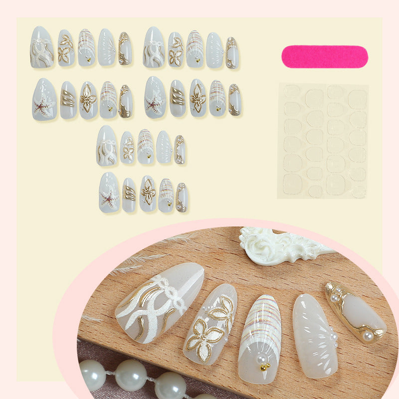 Artificial nail set with luxurious gold embellishments and elegant natural motifs Stornfield