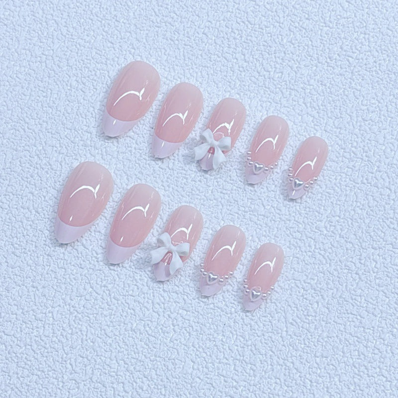 Elegant artificial nails with curved tips and decorative bows Stornfield