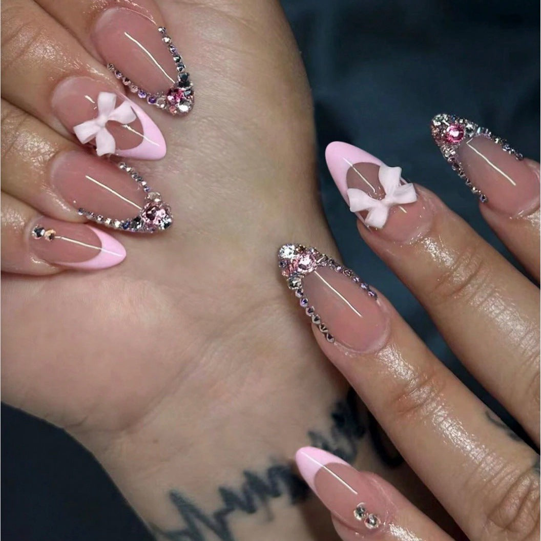 Acrylic nail set with elegant 3D bows and sparkling rhinestone embellishments Stornfield