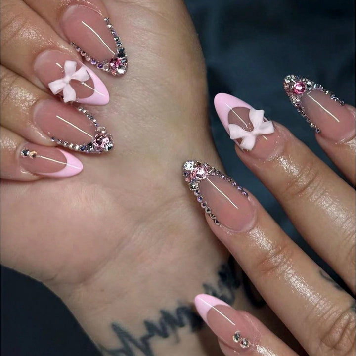 Acrylic nail set with elegant 3D bows and sparkling rhinestone embellishments Stornfield
