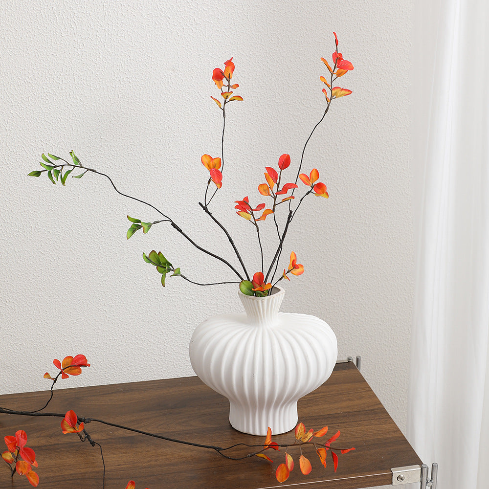 Artificial flower branch with vibrant orange flowers