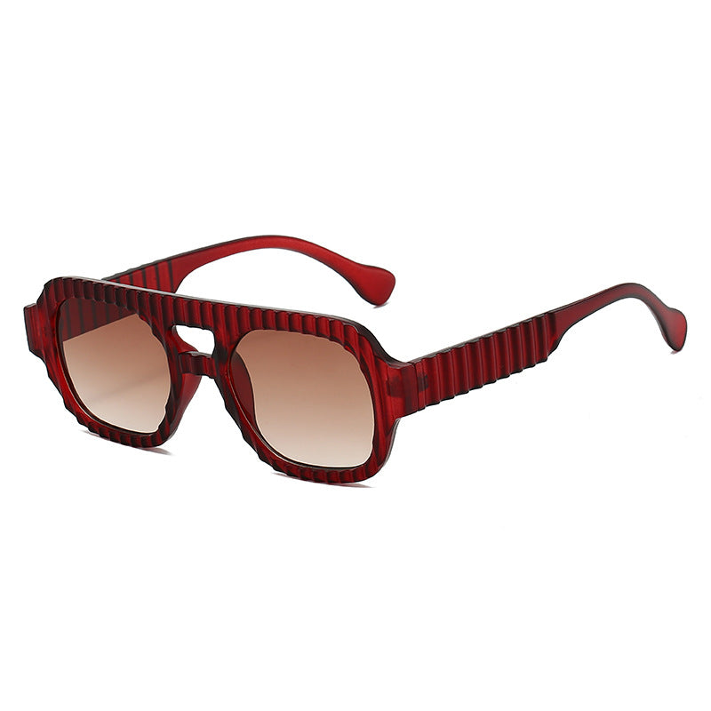 Ladies fashionable sunglasses in futuristic design with textured frame Stornfield