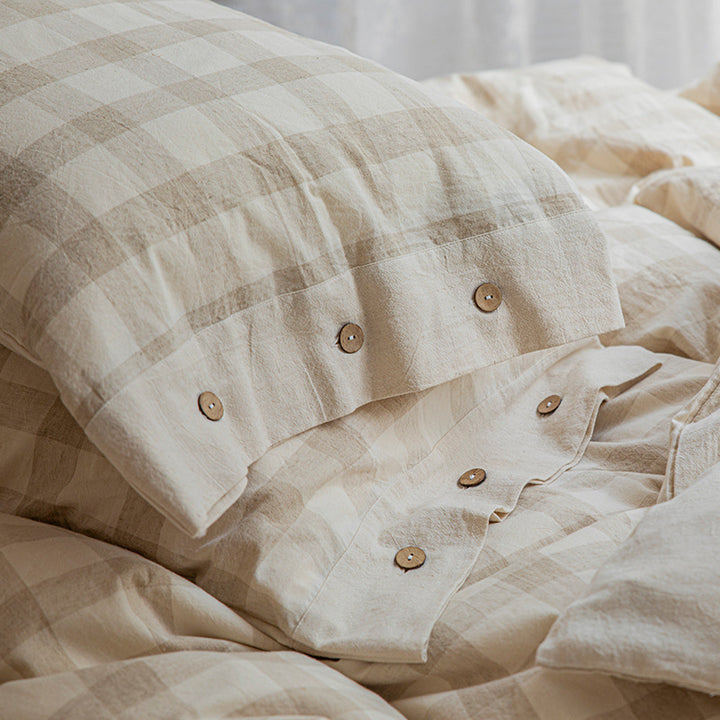 Reversible linen look duvet cover with large check pattern and wooden button closure