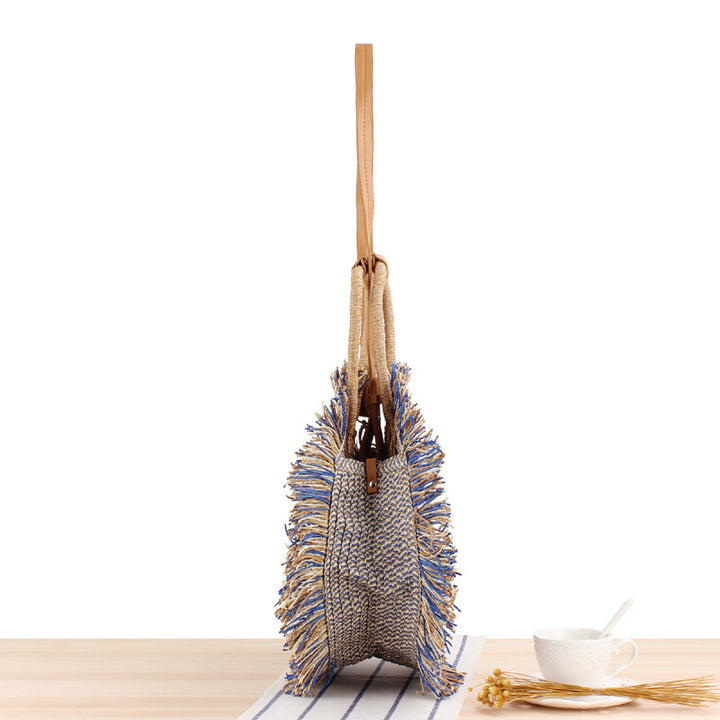Round Bast shoulder bag with fringes and leather handles Stornfield