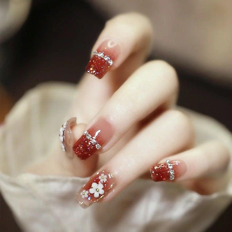 Artistic Press-On Nail Art with Floral and Glitter Accents Stornfield