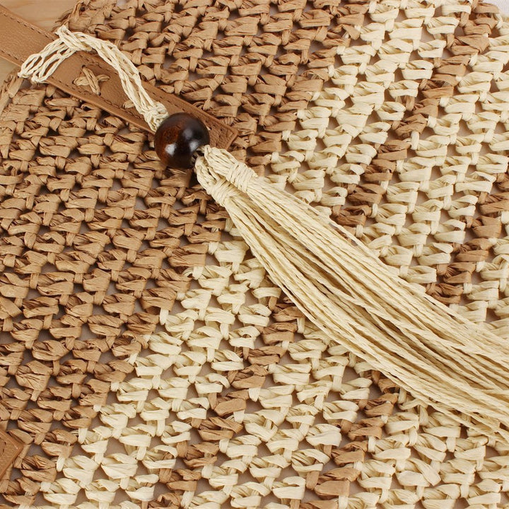 Handbag made of braided natural material with decorative tassel pendant Stornfield