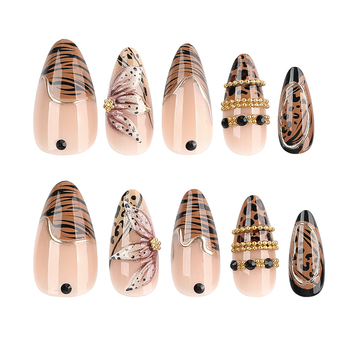 Artful stiletto nail with floral accents and gold embellishments Stornfield