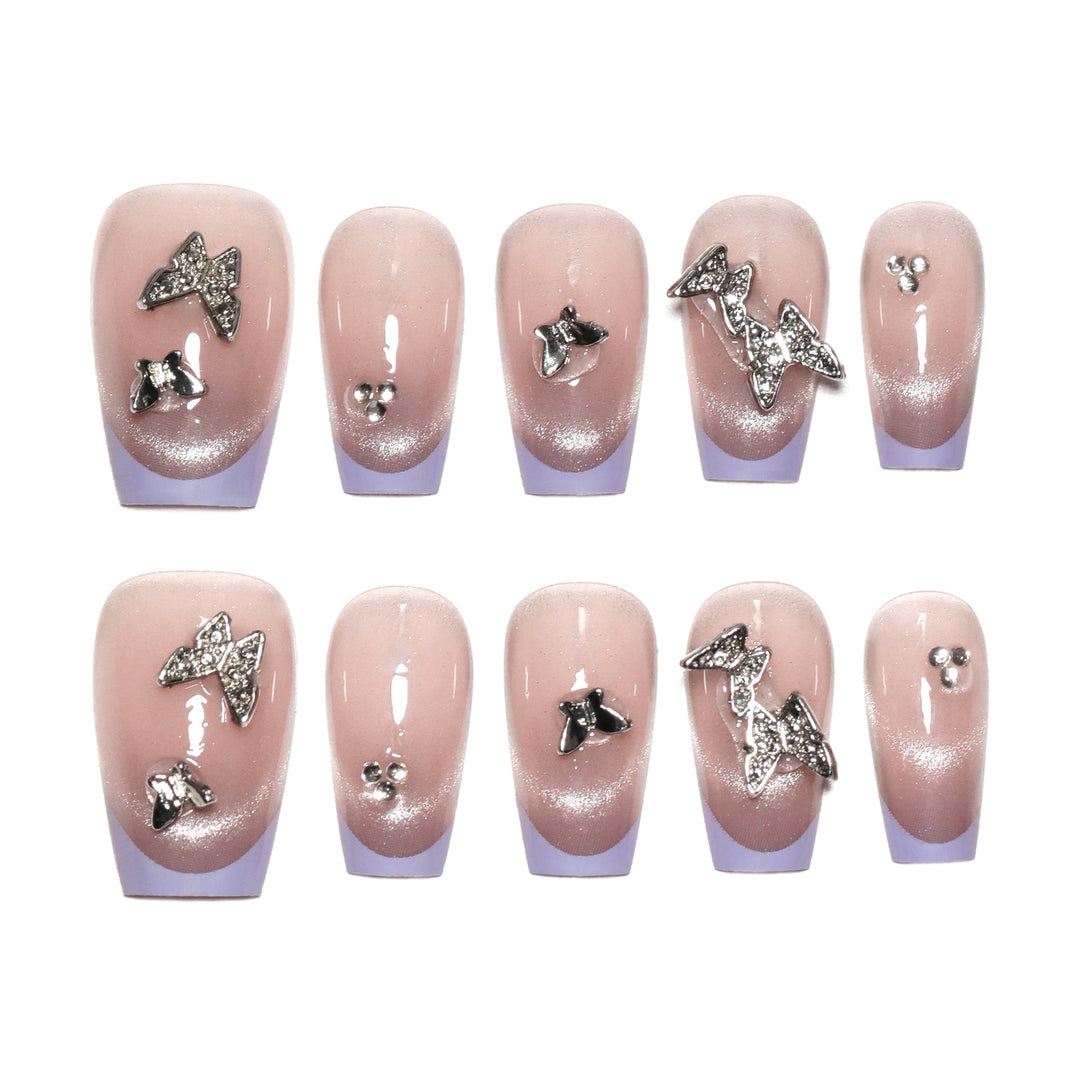 Artificial nail extensions with glitter design and elegant accents Stornfield