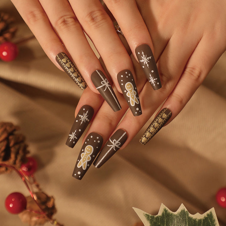 Artificial nail art with festive gingerbread design Stornfield