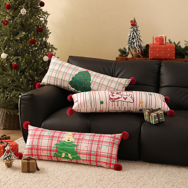 Long decorative lumbar and neck pillow in Christmas check with pompom and dog-tree motif Stornfield