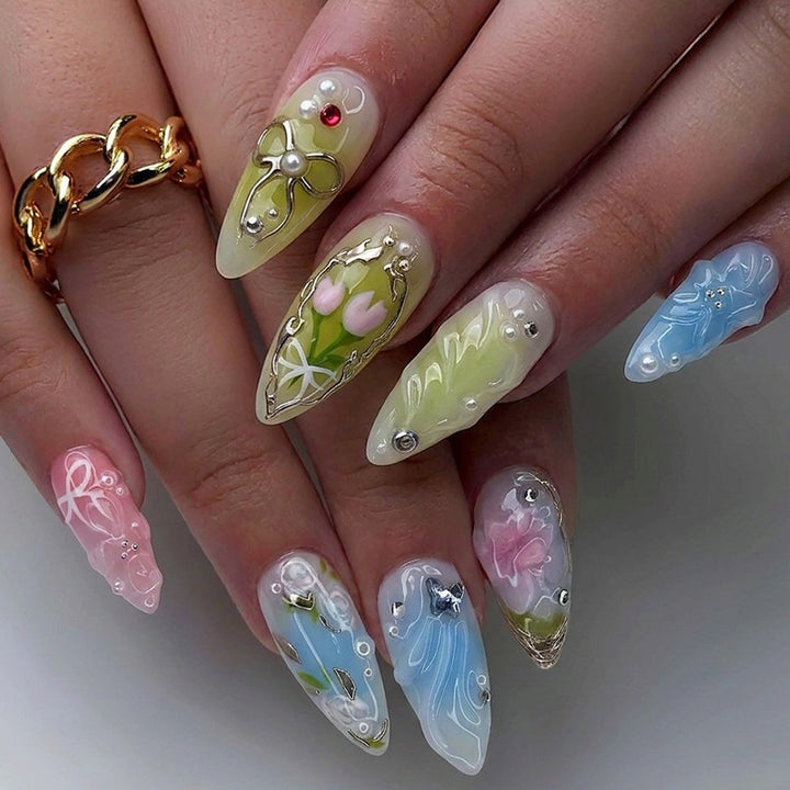 Creative nail set with hand-drawn floral patterns and glitter accents Stornfield