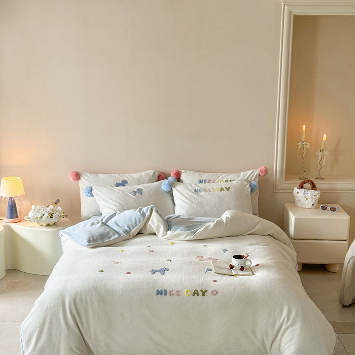 Cozy cotton bedding set with pom-pom appliques and embroidered lettering