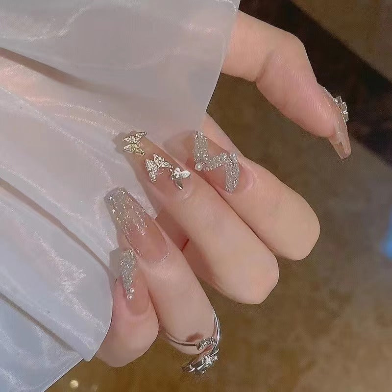Glamorous nail art with rhinestone and butterfly elements Stornfield
