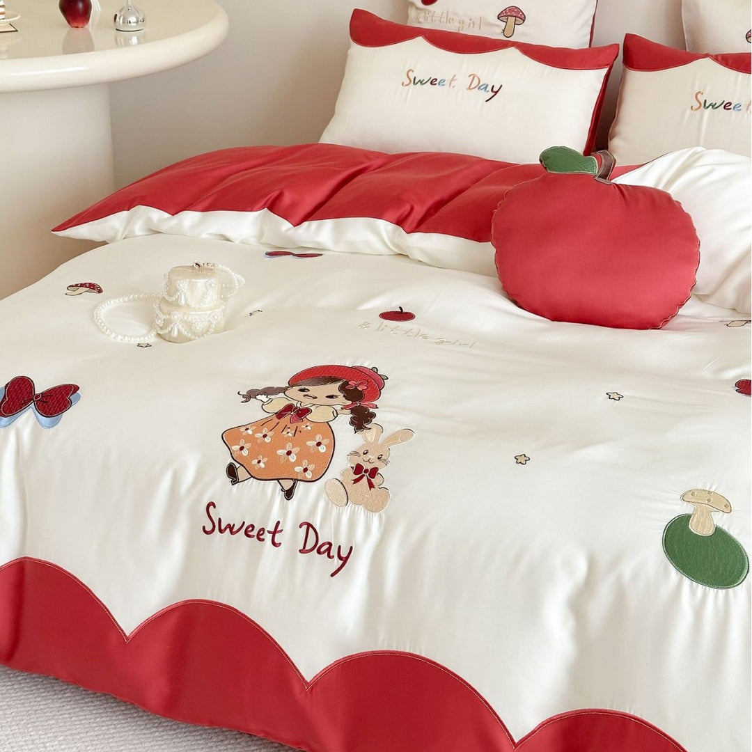 Bedding set with embroidered doll and apple motifs