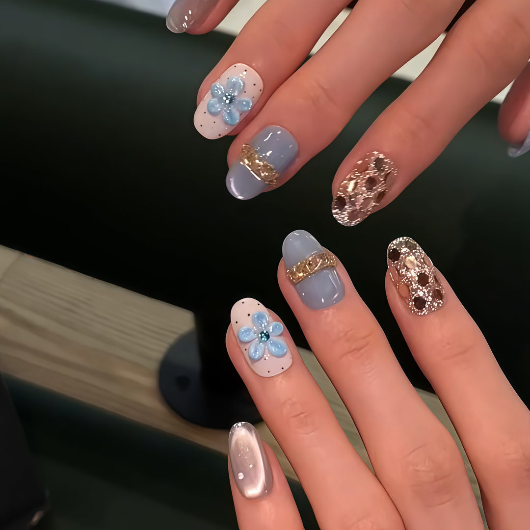 Artificial nails with luxurious glitter details and floral accents Stornfield