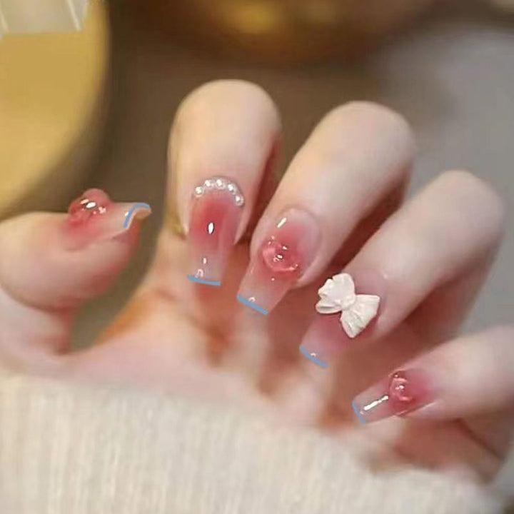 Artistic Nail Art with Glitter and Flower Applications Stornfield