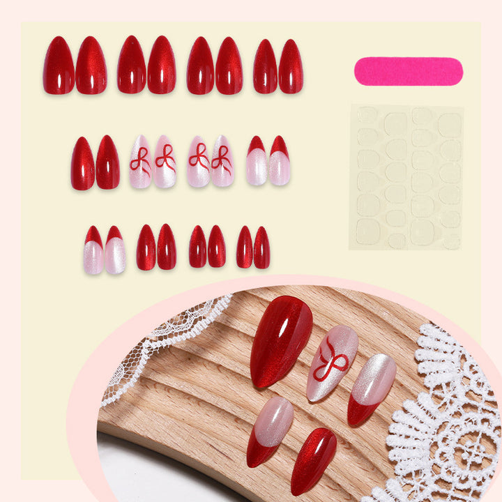 Artificial nail set with elegant red and delicate bow accents Stornfield