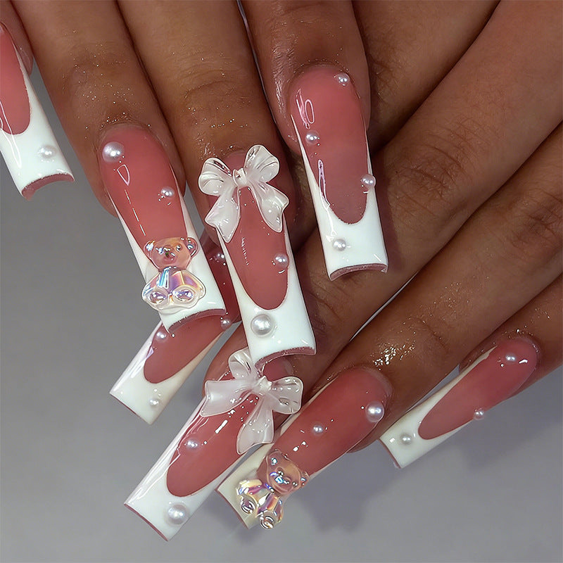 Elegant artificial nails with delicate bows and pearls Stornfield