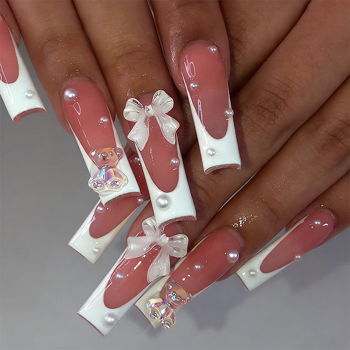Elegant artificial nails with delicate bows and pearls Stornfield