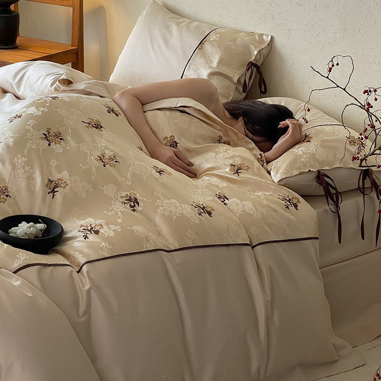 Satin bedding set in jacquard look with floral embroidery details and ribbon ties