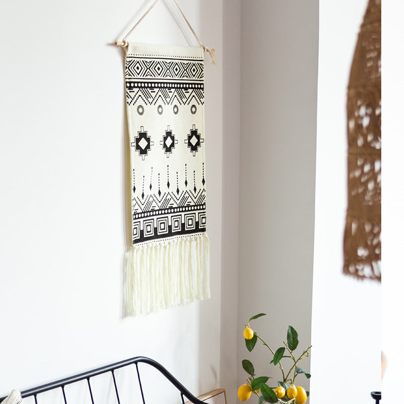 Woven cotton blend wall hanging with graphic ethnic pattern and long fringes Stornfield