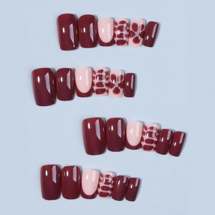 Artificial nail set with elegant geometric designs and accentuating rhinestone details Stornfield