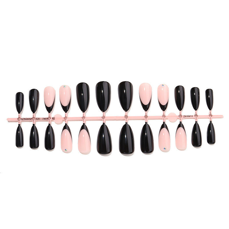 Acrylic nail set with elegant black-pink design and rhinestone-embellished accents Stornfield